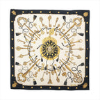 Hermès Carré 90 Les Clés silk scarf with black border, ivory center, ornate gold key motifs, black tassels and gold stud details.
