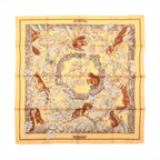 Hermès Carré 90 Casse Noisette yellow silk scarf with red squirrels, leafy branches and brown, cream and green botanical details.
