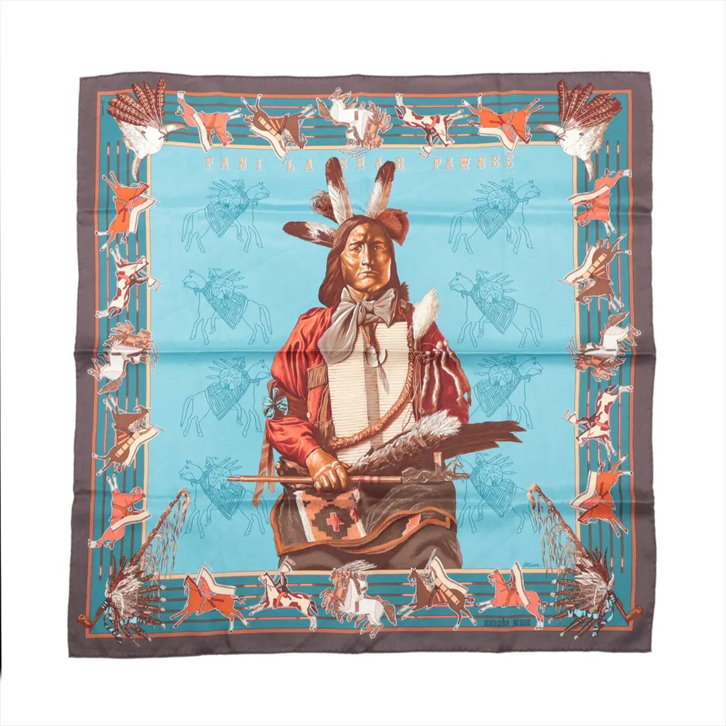 Hermès Carré 70 Pani La Shar Pawnee silk scarf with blue center, brown border, central portrait, horse motifs and feather details.