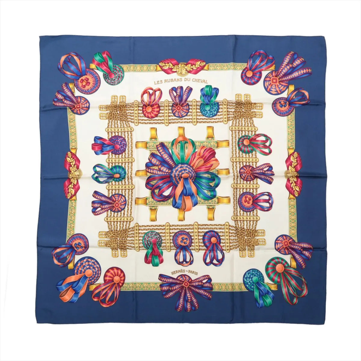 Hermès Carré 90 Les Rubans du Cheval silk scarf with navy border, ivory center, multicolor ribbon rosettes, bows and gold harness motifs.
