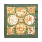 Hermès Carré 90 green silk scarf with illustrated seasonal woodland scenes featuring squirrels, birds, deer, trees and floral details.