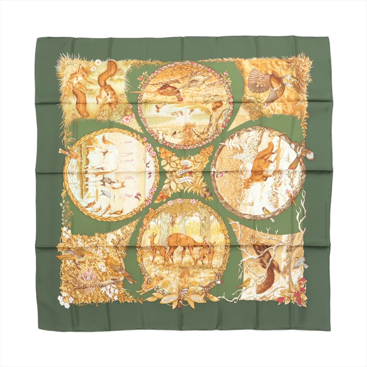 Hermès Carré 90 green silk scarf with illustrated seasonal woodland scenes featuring squirrels, birds, deer, trees and floral details.