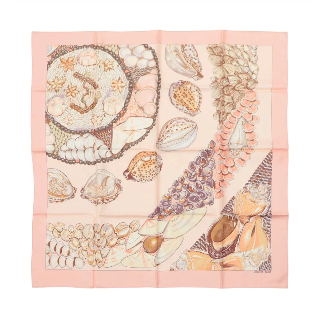Pink square scarf with detailed seashell illustrations, layered shell strands and peach, cream and brown accents on a pale pink background.
