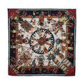 Hermès Kachinas silk scarf with navy blue border, colorful ceremonial figures, feathered headdresses and red, green and cream geometric motifs.