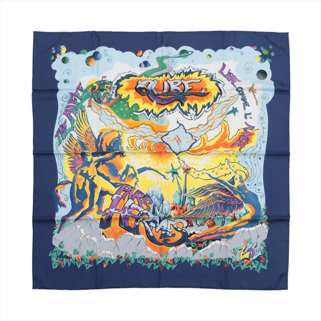 Hermès silk scarf with navy blue border, colorful winged figures, orange and yellow artwork, stars and bold multicolor graphic lettering.