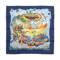 Hermès silk scarf with navy blue border, colorful winged figures, orange and yellow artwork, stars and bold multicolor graphic lettering.